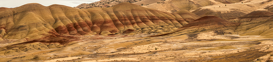 Sweeping View of the Painted Hills; painted hills; john day fossil beds; national monument; high; desert; oregon; or; color; colorful; scene; scenic; sunset; nature; natural; in; and; the; a; on; over; to; of; with; under; above; against; Loree Johnson